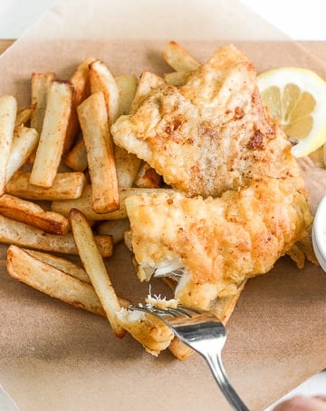 These healthy fish and chips are crispy on the outside and juicy, tender, and flakey on the inside. Pair it with homemade tartar sauce and say hello to comfort food heaven! | aheadofthyme.com