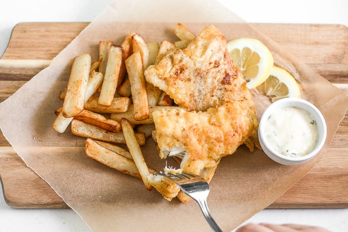 These healthy fish and chips are crispy on the outside and juicy, tender, and flakey on the inside. Pair it with homemade tartar sauce and say hello to comfort food heaven! | aheadofthyme.com