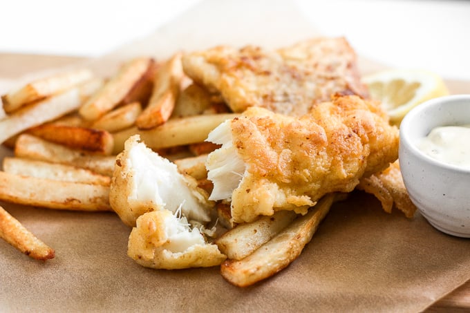 These healthy fish and chips are crispy on the outside and juicy, tender, and flakey on the inside. Pair it with homemade tartar sauce and say hello to comfort food heaven! | aheadofthyme.com