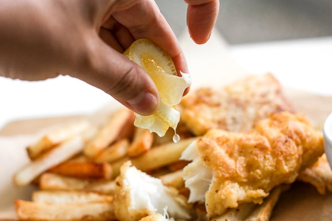 These healthy fish and chips are crispy on the outside and juicy, tender, and flakey on the inside. Pair it with homemade tartar sauce and say hello to comfort food heaven! | aheadofthyme.com