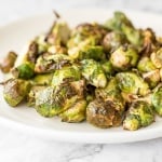 Tender and crispy roasted air fryer brussels sprouts cooks in less than 12 minutes with very little oil. It is a holiday table game changer. | aheadofthyme.com