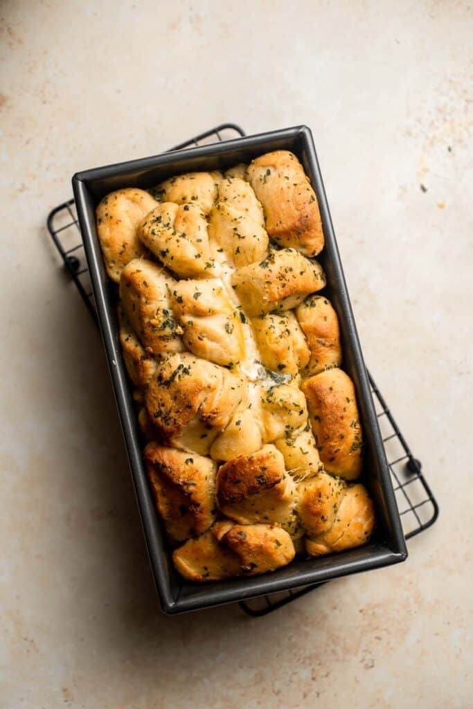 Homemade Pull Apart Garlic Bread is fluffy, buttery, flavourful, and tears easily for optimal sharing. You won't be able to stop grabbing these bites! | aheadofthyme.com