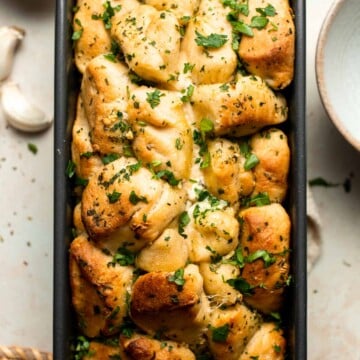 Homemade Pull Apart Garlic Bread is fluffy, buttery, flavourful, and tears easily for optimal sharing. You won't be able to stop grabbing these bites! | aheadofthyme.com