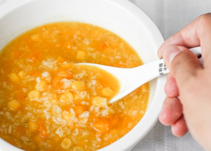 When east meets west, savoury pumpkin congee rice porridge with corn is born. It's thick and creamy -- the ultimate fall comfort food. | aheadofthyme.com