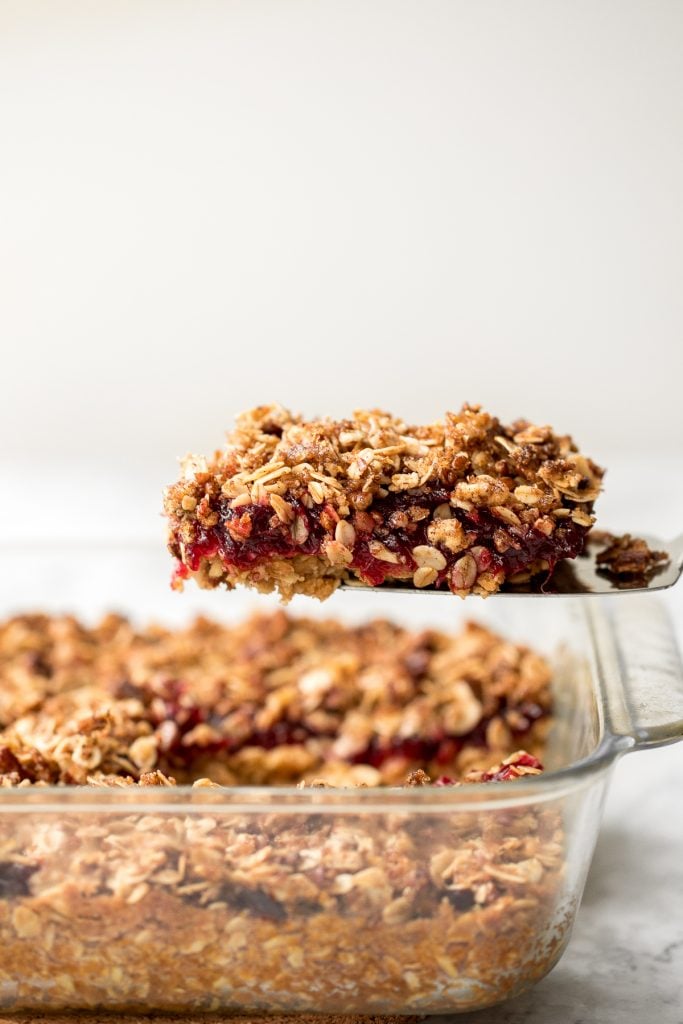 Easy cranberry sauce oat bars with a buttery crust, cranberry sauce filling, and crumbly pecan oat topping is the best way to use leftover cranberry sauce. | aheadofthyme.com