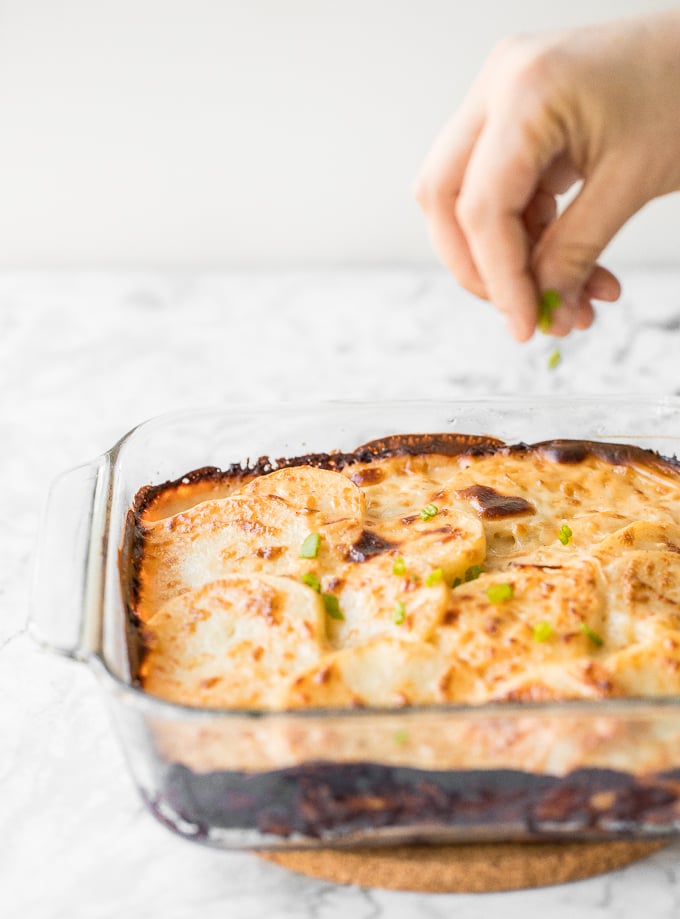 Rich and creamy potatoes au gratin is the ultimate comfort food made with sliced potatoes, cheese, and milk. It's the perfect side dish for the holidays. | aheadofthyme.com