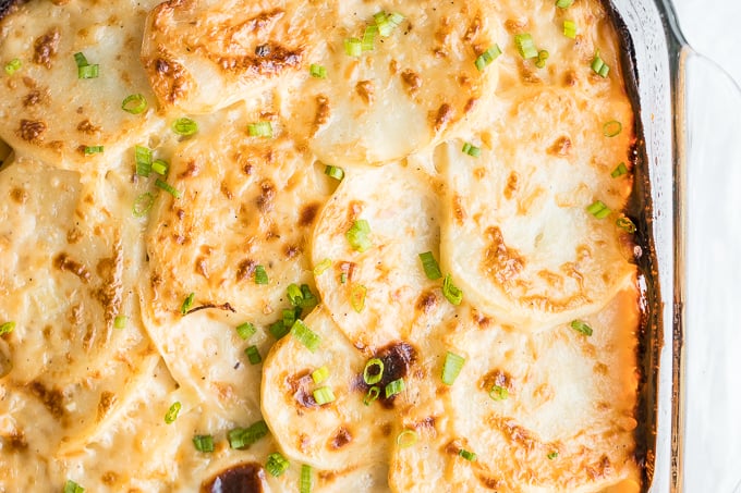 Rich and creamy potatoes au gratin is the ultimate comfort food made with sliced potatoes, cheese, and milk. It's the perfect side dish for the holidays. | aheadofthyme.com
