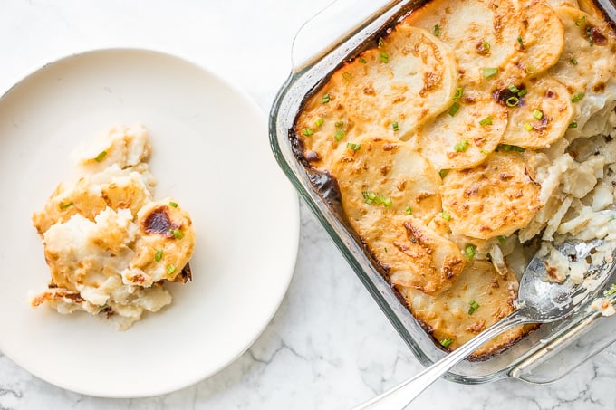 Rich and creamy potatoes au gratin is the ultimate comfort food made with sliced potatoes, cheese, and milk. It's the perfect side dish for the holidays. | aheadofthyme.com