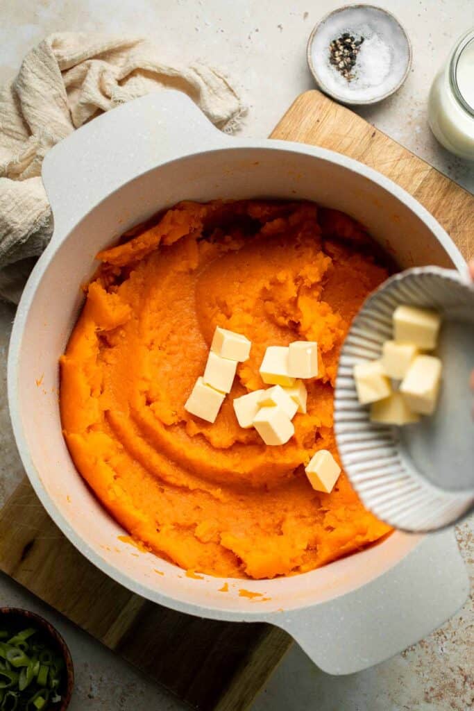 Creamy, buttery savory mashed sweet potatoes with garlic, herbs, and green onions is the perfect cozy side for dinner or holidays. | aheadofthyme.com