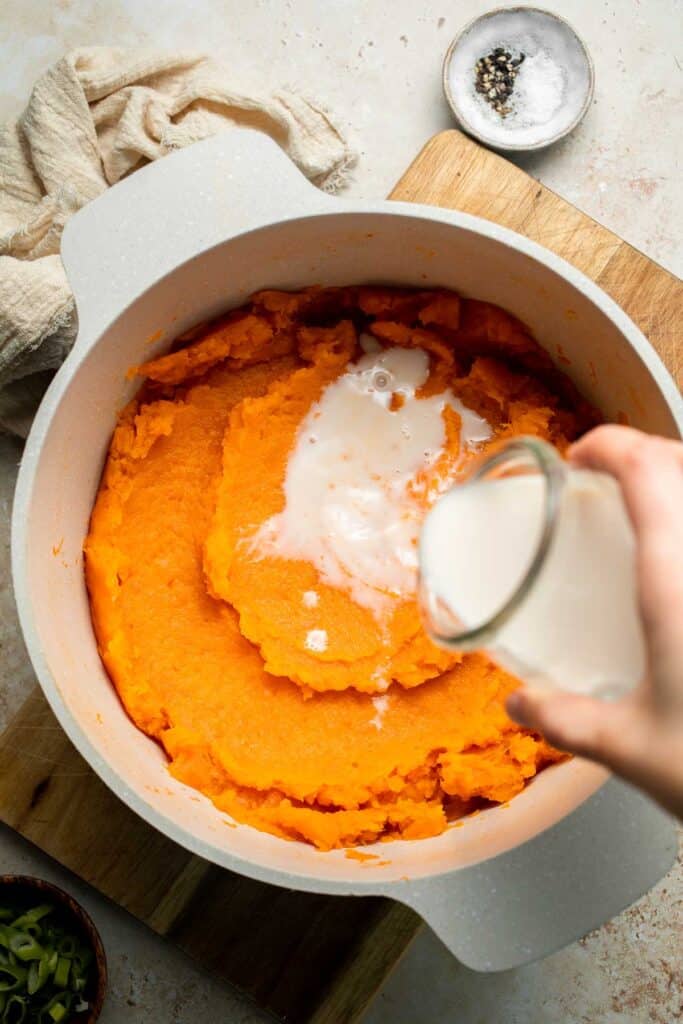 Creamy, buttery savory mashed sweet potatoes with garlic, herbs, and green onions is the perfect cozy side for dinner or holidays. | aheadofthyme.com