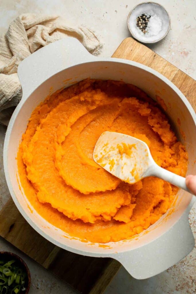 Creamy, buttery savory mashed sweet potatoes with garlic, herbs, and green onions is the perfect cozy side for dinner or holidays. | aheadofthyme.com