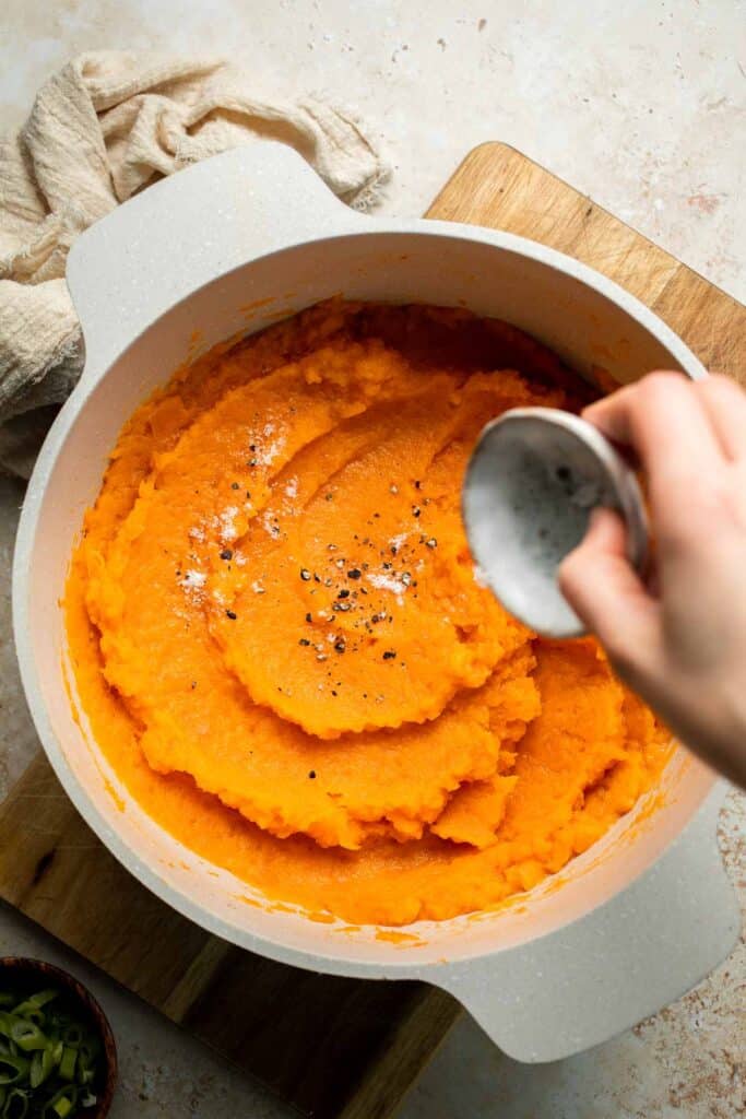 Creamy, buttery savory mashed sweet potatoes with garlic, herbs, and green onions is the perfect cozy side for dinner or holidays. | aheadofthyme.com