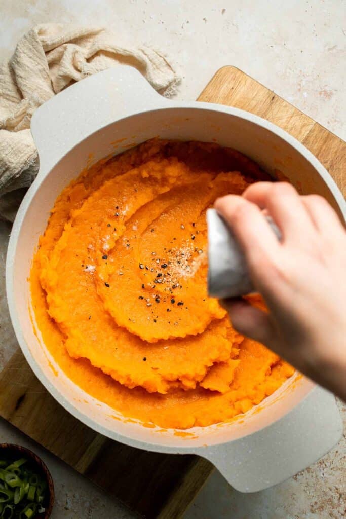 Creamy, buttery savory mashed sweet potatoes with garlic, herbs, and green onions is the perfect cozy side for dinner or holidays. | aheadofthyme.com