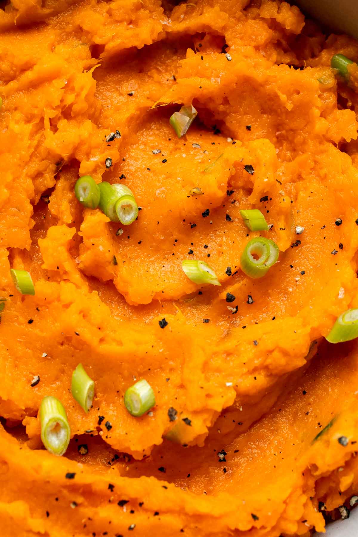 Creamy, buttery savory mashed sweet potatoes with garlic, herbs, and green onions is the perfect cozy side for dinner or holidays. | aheadofthyme.com