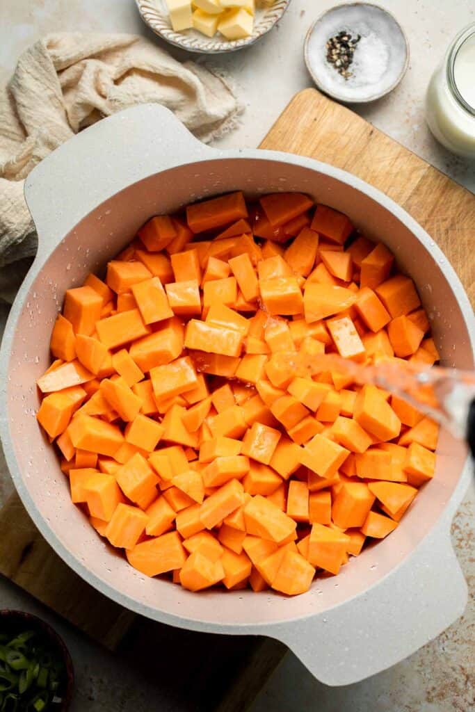 Creamy, buttery savory mashed sweet potatoes with garlic, herbs, and green onions is the perfect cozy side for dinner or holidays. | aheadofthyme.com