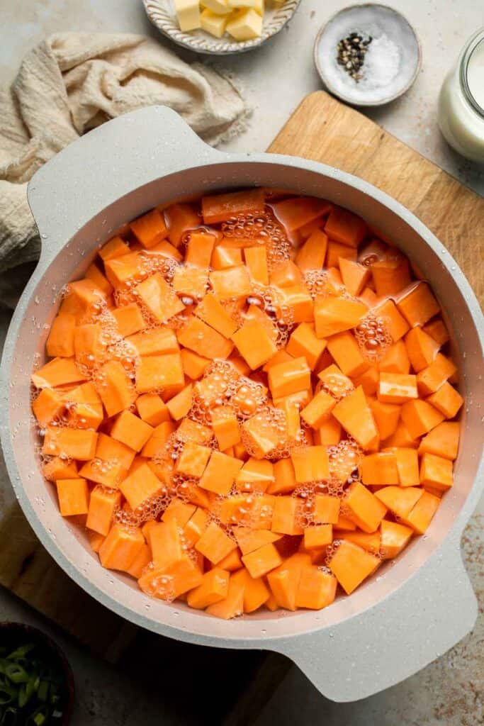 Creamy, buttery savory mashed sweet potatoes with garlic, herbs, and green onions is the perfect cozy side for dinner or holidays. | aheadofthyme.com