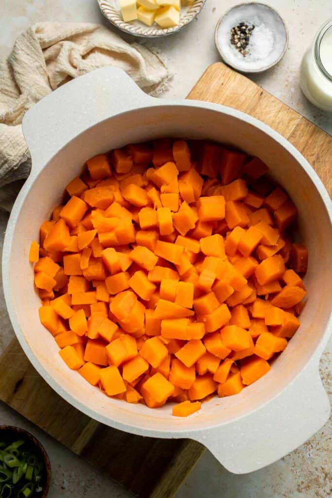 Creamy, buttery savory mashed sweet potatoes with garlic, herbs, and green onions is the perfect cozy side for dinner or holidays. | aheadofthyme.com