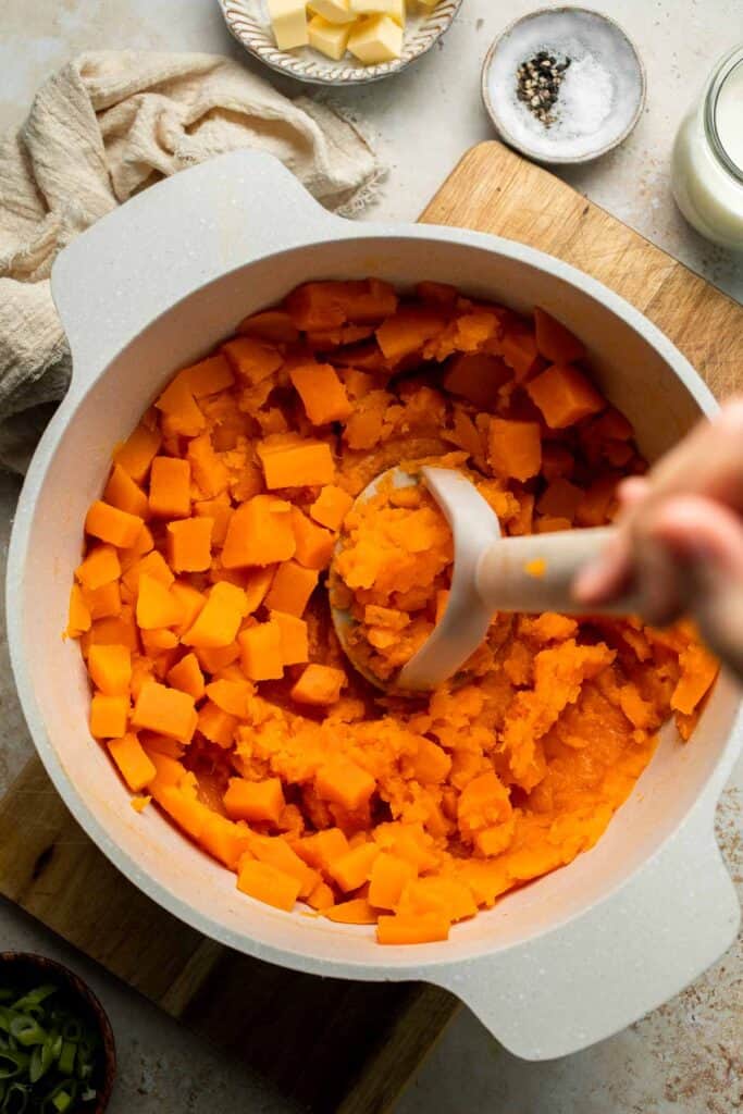 Creamy, buttery savory mashed sweet potatoes with garlic, herbs, and green onions is the perfect cozy side for dinner or holidays. | aheadofthyme.com
