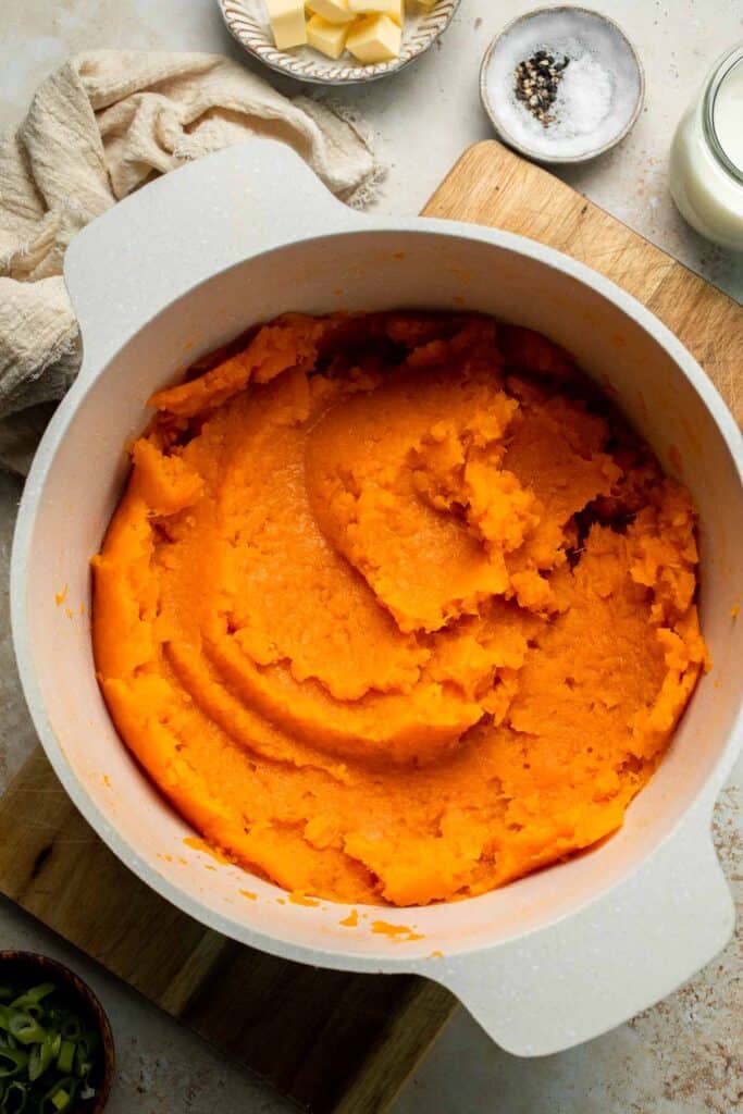 Creamy, buttery savory mashed sweet potatoes with garlic, herbs, and green onions is the perfect cozy side for dinner or holidays. | aheadofthyme.com