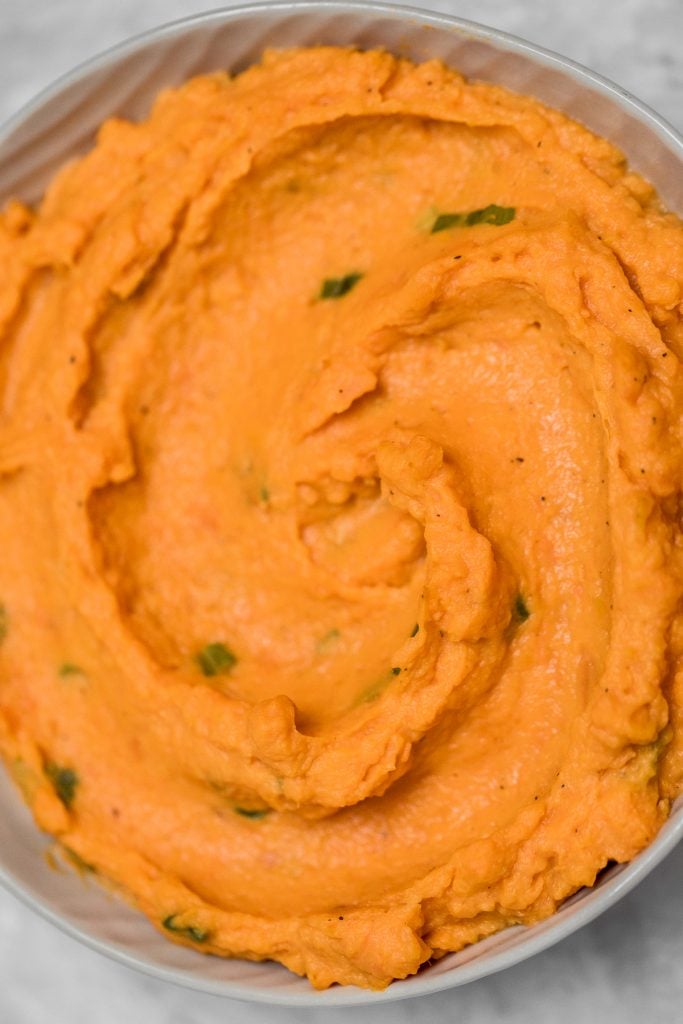 Velvety, smooth, and creamy, this savoury mashed sweet potatoes dish is quick and easy and can be made ahead of time -- it is the perfect side for your holiday meal. | aheadofthyme.com