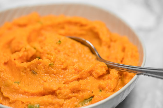Velvety, smooth, and creamy, this savoury mashed sweet potatoes dish is quick and easy and can be made ahead of time -- it is the perfect side for your holiday meal. | aheadofthyme.com