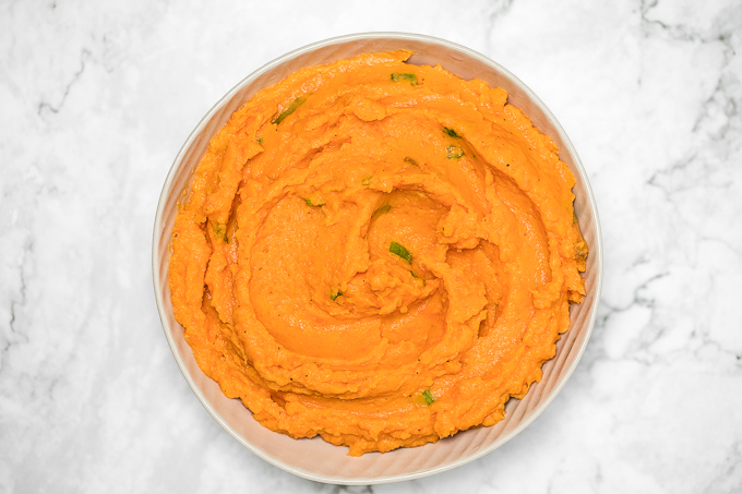 Velvety, smooth, and creamy, this savoury mashed sweet potatoes dish is quick and easy and can be made ahead of time -- it is the perfect side for your holiday meal. | aheadofthyme.com