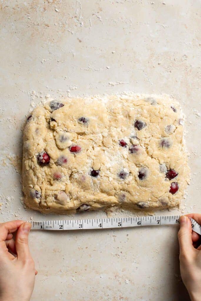 Cranberry Scones with Orange Glaze are a quick and easy holiday brunch recipe that is flavorful and flaky. They're soft and moist inside yet crisp outside. | aheadofthyme.com