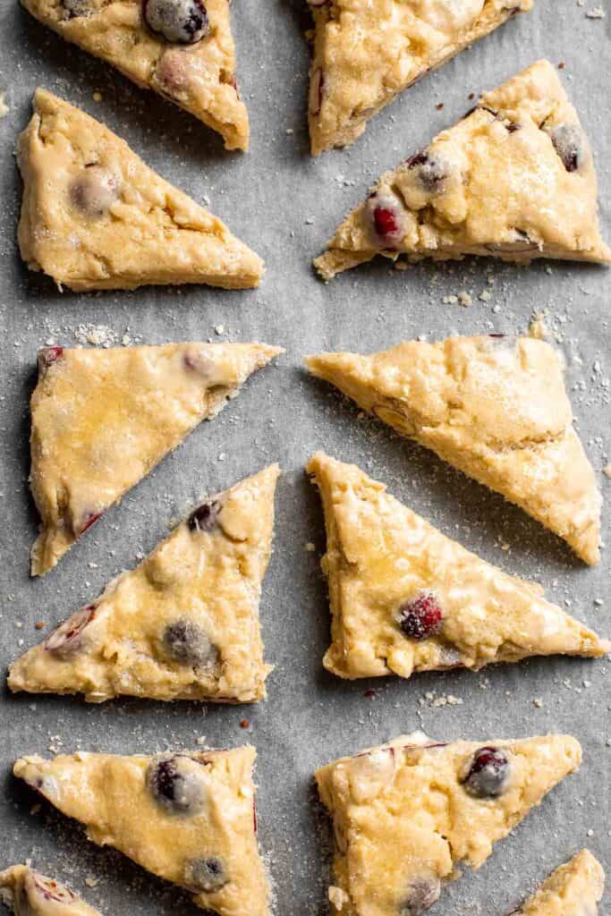 Cranberry Scones with Orange Glaze are a quick and easy holiday brunch recipe that is flavorful and flaky. They're soft and moist inside yet crisp outside. | aheadofthyme.com
