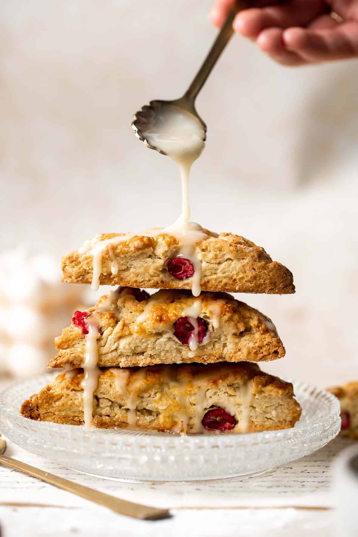 Cranberry Scones with Orange Glaze are a quick and easy holiday brunch recipe that is flavorful and flaky. They're soft and moist inside yet crisp outside. | aheadofthyme.com