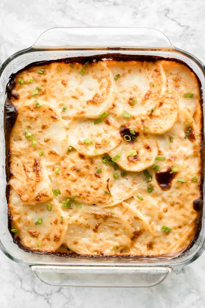 Rich and creamy potatoes au gratin is the ultimate comfort food made with sliced potatoes, cheese, and milk. It's the perfect side dish for the holidays. | aheadofthyme.com