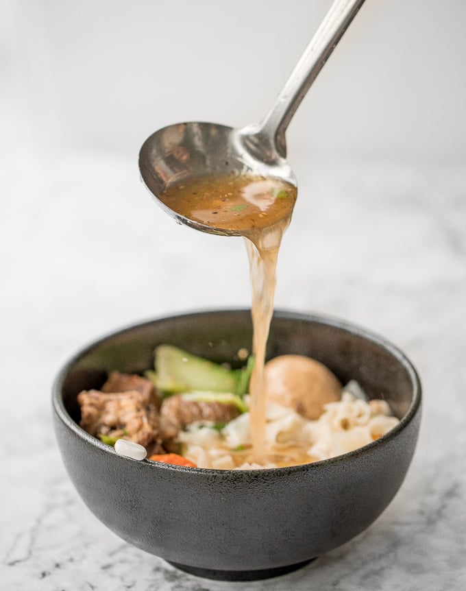 An easy weeknight dinner option, this hearty and oily slow cooker Asian beef noodle soup is packed with beef chunks, vegetables, noodles, and Asian spices and flavours. | aheadofthyme.com