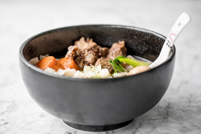 An easy weeknight dinner option, this hearty and oily slow cooker Asian beef noodle soup is packed with beef chunks, vegetables, noodles, and Asian spices and flavours. | aheadofthyme.com