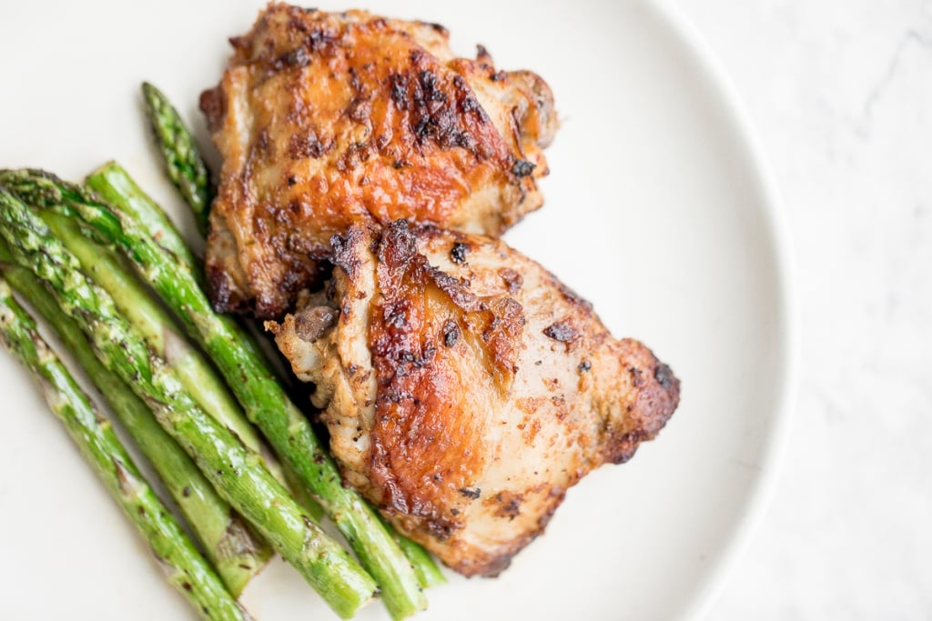 Crisp on the outside and tender inside, air fryer asparagus cooks in just 6 minutes! It is tossed in very little olive oil with garlic and seasonings. | aheadofthyme.com