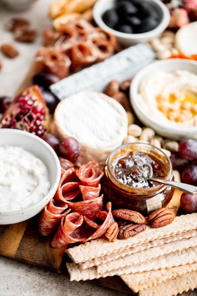 This easy charcuterie board is the perfect appetizer to impress with minimal effort— made with cheese, cured meats, crackers, dips, olives, fruit, and nuts. | aheadofthyme.com