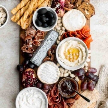 This easy charcuterie board is the perfect appetizer to impress with minimal effort— made with cheese, cured meats, crackers, dips, olives, fruit, and nuts. | aheadofthyme.com