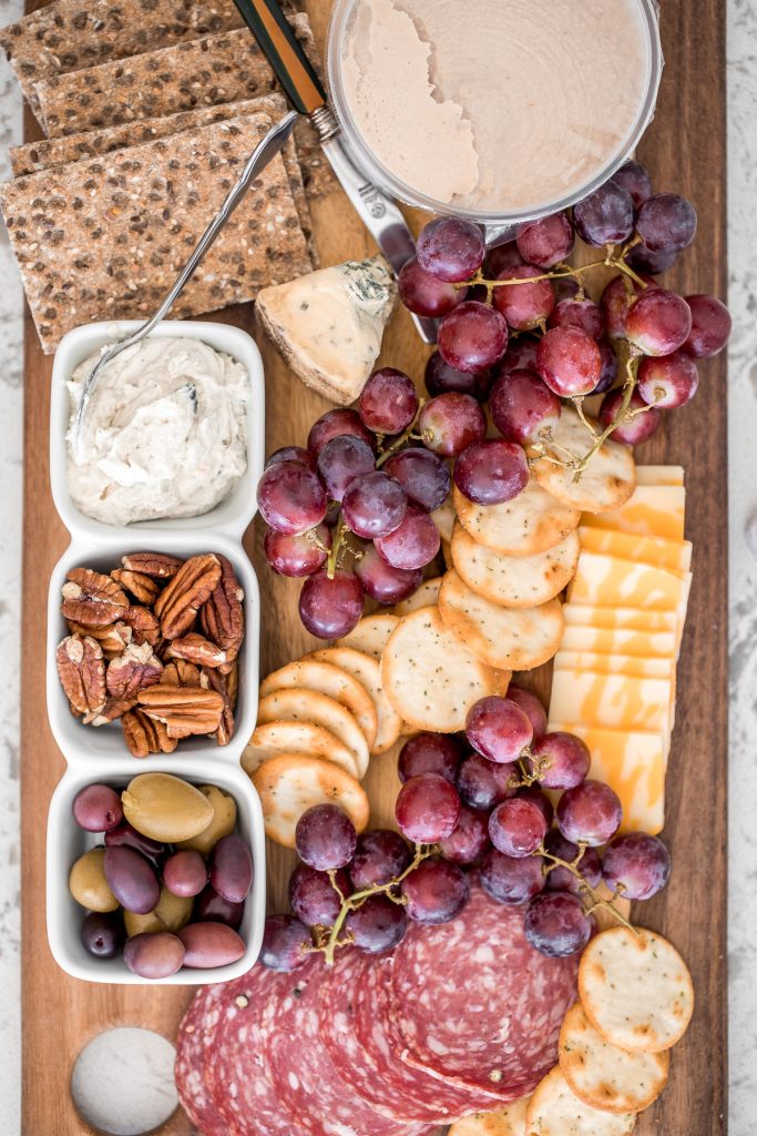 Take your party to another level with this easy to follow guide on how to make a charcuterie board, with a variety of cheese, cured meats, crackers, olives and dips. | aheadofthyme.com