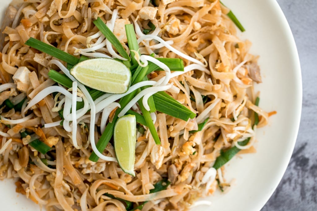 No more takeout when you can make flavourful, restaurant-style, authentic chicken Pad Thai at home in just 10 minutes. It's sweet, savoury, sour and nutty. | aheadofthyme.com