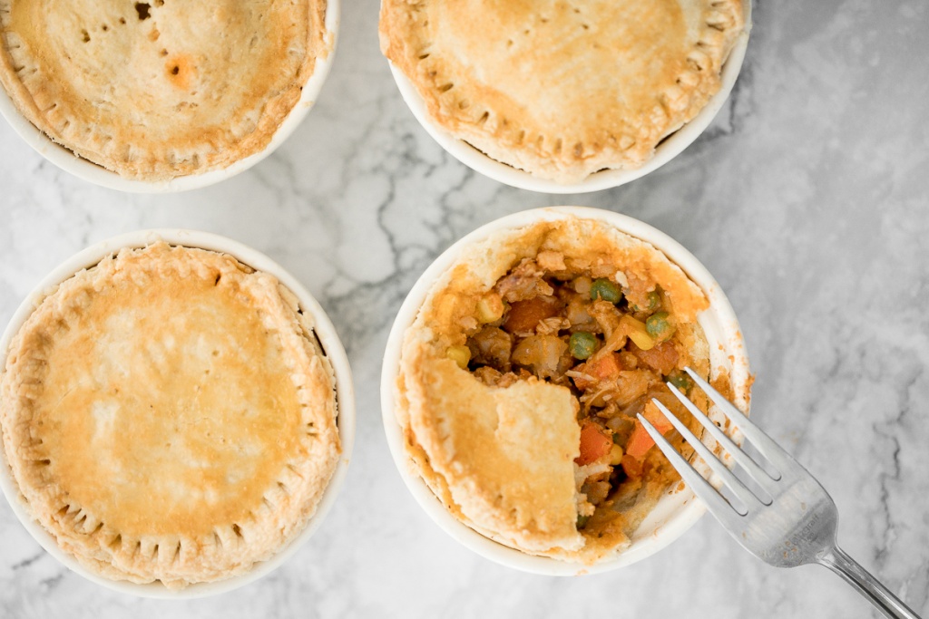 East meets west in these butter chicken pot pies with a flaky, buttery puff pastry crust, creamy butter chicken filling inside, and a whole lot of comfort. | aheadofthyme.com
