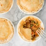 East meets west in these butter chicken pot pies with a flaky, buttery puff pastry crust, creamy butter chicken filling inside, and a whole lot of comfort. | aheadofthyme.com