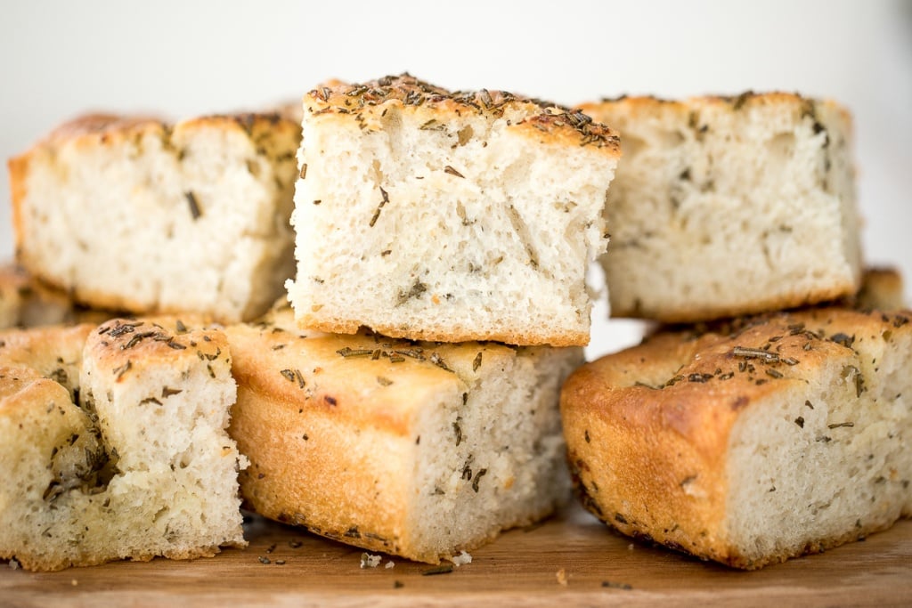 No knead, easy rosemary garlic focaccia bread is thick with a perfect golden and crispy texture on the outside, but soft, fluffy and tender inside. | aheadofthyme.com