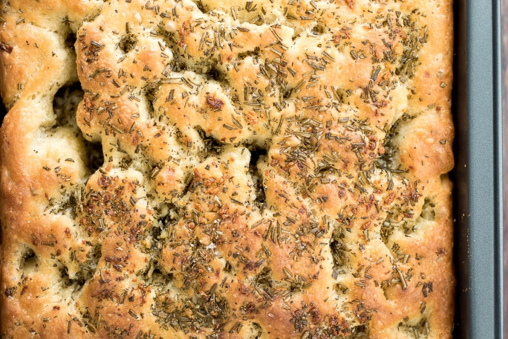 No knead, easy rosemary garlic focaccia bread is thick with a perfect golden and crispy texture on the outside, but soft, fluffy and tender inside. | aheadofthyme.com