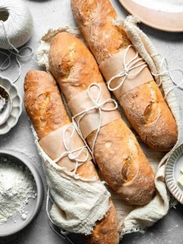 These homemade no knead French Baguettes are just what bread dreams are made of — beautifully golden loaves with a crisp crust and soft, airy interior. | aheadofthyme.com