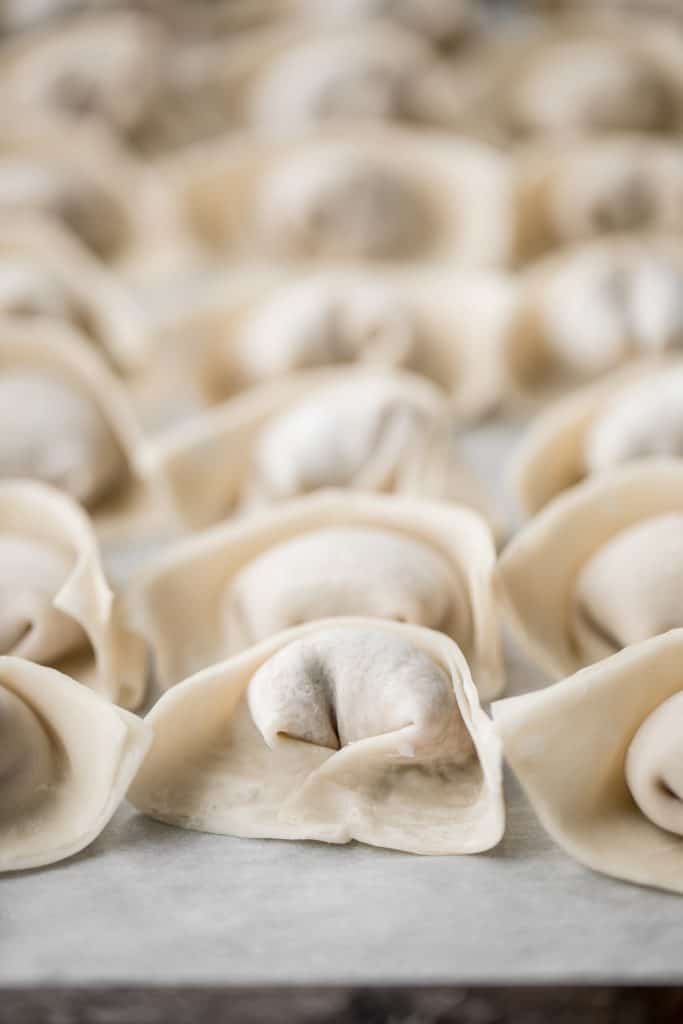 Learn how to make homemade chicken and cilantro wontons to celebrate Chinese new year with this easy to follow recipe and instructions on how to fold wontons. | aheadofthyme.com