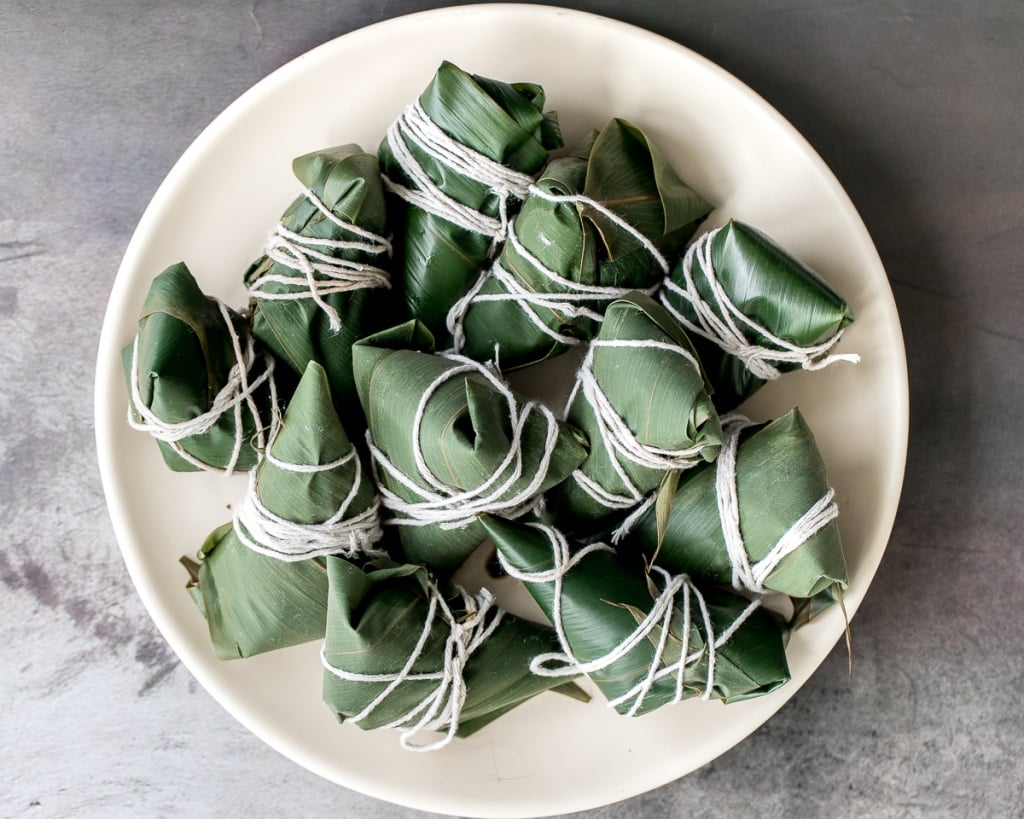 Zongzi Chinese tamales (粽子) or sticky rice dumplings are stuffed with sticky rice, pork belly, and shiitake mushrooms, wrapped inside reed or bamboo leaves. | aheadofthyme.com