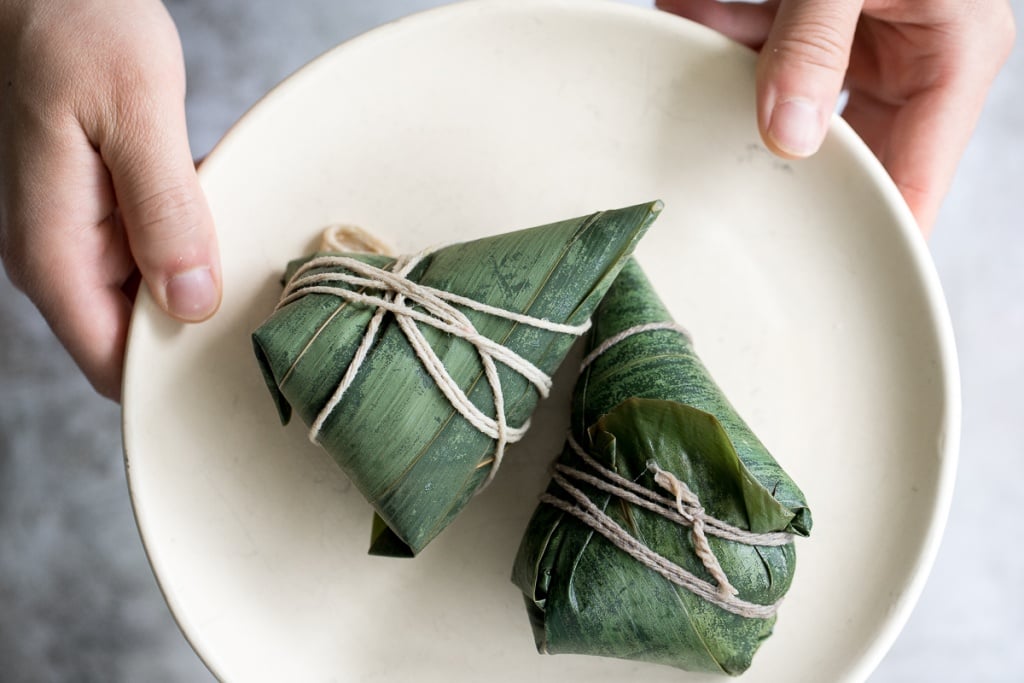 Zongzi Chinese tamales (粽子) or sticky rice dumplings are stuffed with sticky rice, pork belly, and shiitake mushrooms, wrapped inside reed or bamboo leaves. | aheadofthyme.com