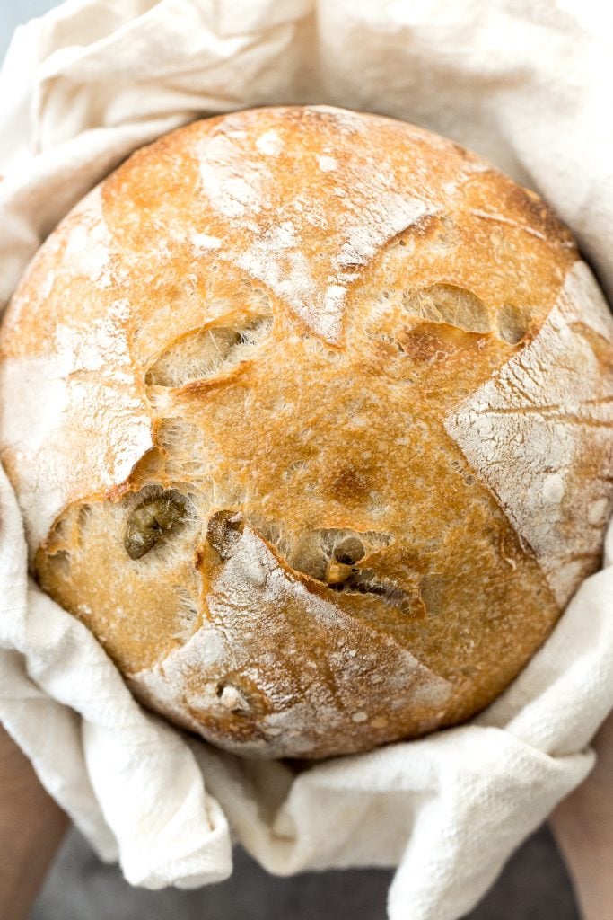 Artisan green olive sourdough bread is airy and chewy, has a signature crispy crust, and is loaded with tangy green olives for a Mediterranean flair. | aheadofthyme.com