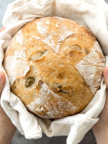 Artisan green olive sourdough bread is airy and chewy, has a signature crispy crust, and is loaded with tangy green olives for a Mediterranean flair. | aheadofthyme.com