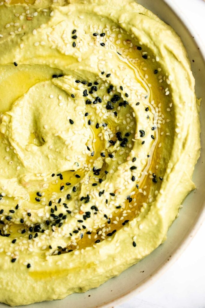 Quick and easy avocado hummus is creamy, smooth, healthy, and delicious. Loaded with chickpeas and avocado, it's the perfect blend of hummus and guacamole. | aheadofthyme.com