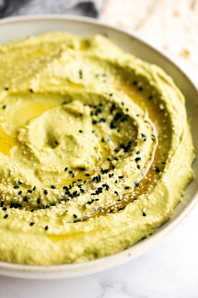 Quick and easy avocado hummus is creamy, smooth, healthy, and delicious. Loaded with chickpeas and avocado, it's the perfect blend of hummus and guacamole. | aheadofthyme.com