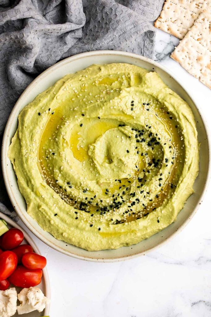 Quick and easy avocado hummus is creamy, smooth, healthy, and delicious. Loaded with chickpeas and avocado, it's the perfect blend of hummus and guacamole. | aheadofthyme.com